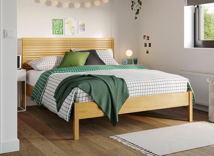 Natural tone wooden bed frame with slatted headboard, styled in a casual student-style room.